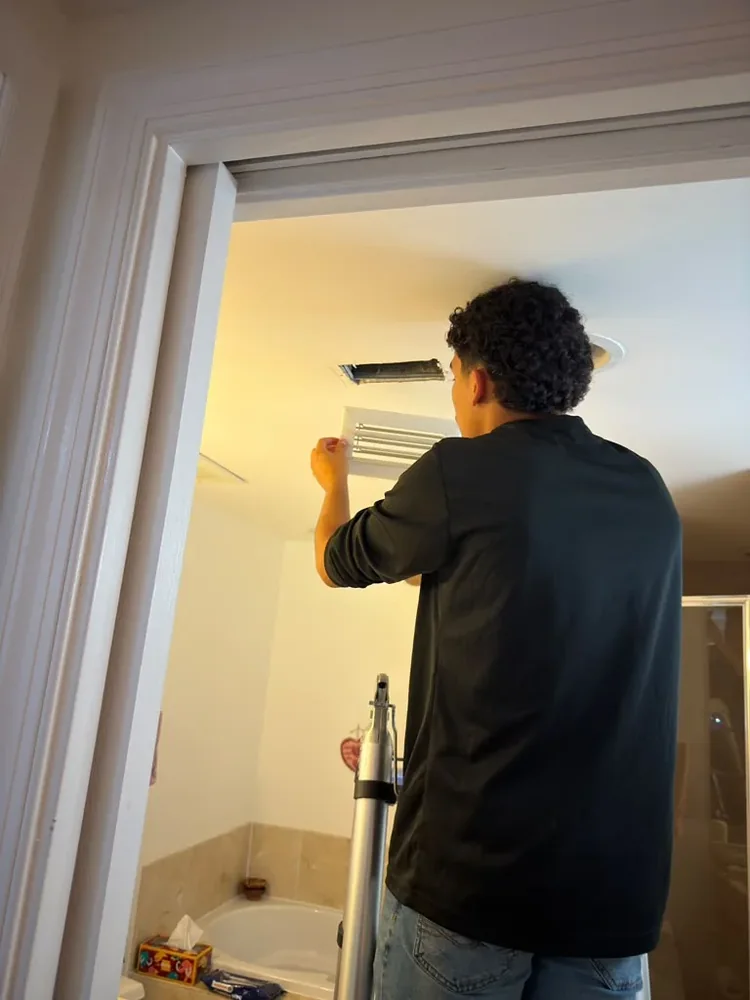 HVAC Solution technician removing return vent cover inside customer home